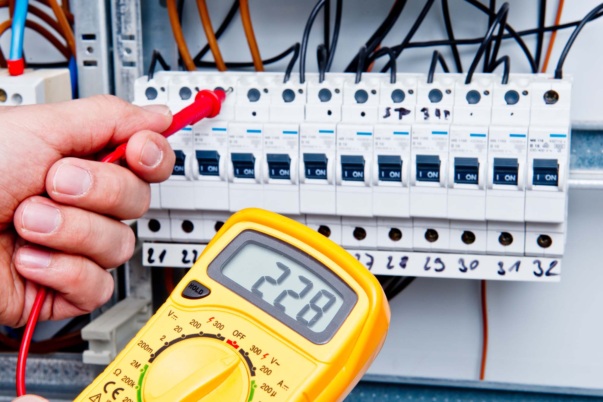 Electrician checking voltage of fuse box in Antrim, Northern Ireland.